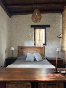 a bedroom with a bed with two pillows and a window at Iris,Tiny house en Las Calles, Traslasierra in Las Calles