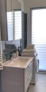 a bathroom with a sink and a mirror at Oasi Casa Vacanze in Loano
