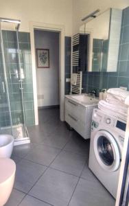 a bathroom with a washing machine and a sink at Oasi Casa Vacanze in Loano