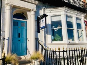 a house with a blue door and a window at The Mayfair in Weymouth