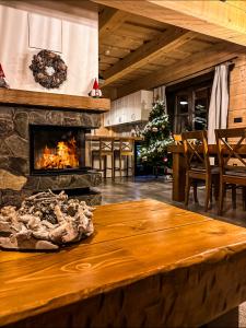 a living room with a fireplace and a table at Drevenica Lesanka in Demanovska Dolina