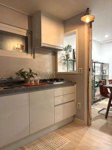 a kitchen with white cabinets and a stove at 스테이아지트 in Seoul +20 photos