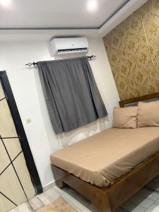 En eller flere senge i et værelse på Résidence KENZO