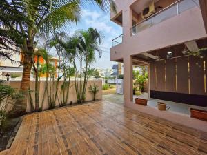 una casa con pavimento in legno e palme di ll EMPYREAN STAY ll SUPREME VILLA ll 3BHK II PVT POOL II MINI BAR AREA II AC a Lonavala