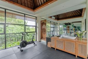 a bathroom with a large window and a gym at Aresty 3 Bedroom Villa Canggu in Canggu