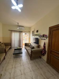 a living room with two couches and a table at Seaview horizon apartment in Sowayma