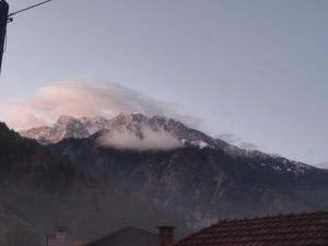 a mountain covered in clouds with a mountain at Konitsa Escape Apartment in Konitsa +2 photos