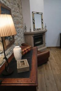 a living room with a table with a lamp and a fireplace at Nature House Lagos do Sabor in Torre de Moncorvo +44 photos