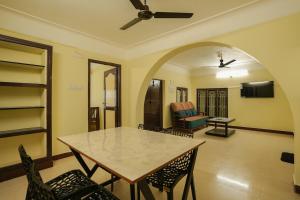 a dining room with a table and chairs and a living room at Ashu Homestay Nest 1 in Pondicherry