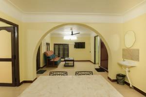 an archway in a living room with a couch and a table at Ashu Homestay Nest 1 in Pondicherry