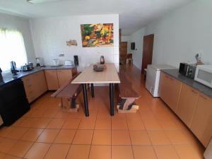 a kitchen with a wooden table in a room at Vaaldamhuis in Oranjeville +40 photos