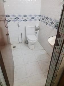 a bathroom with a toilet and a sink at Jannat Villa in Dhaka
