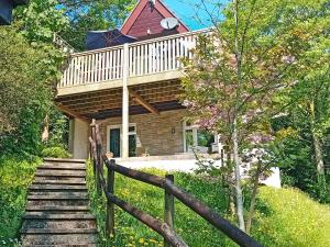 a house with a staircase leading up to a porch at Valley Lodge - Uk49228 in Gunnislake