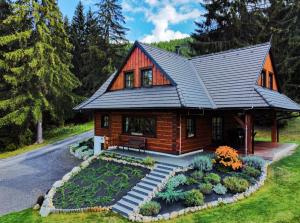 a log home with a metal roof at Drevenica Lesanka in Belá +54 photos