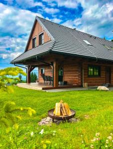 a log cabin with a fire in front of it at Drevenica Lesanka in Belá