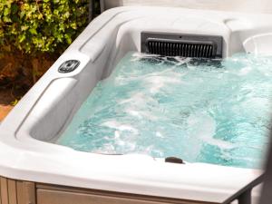 a jacuzzi tub with blue water in it at Killerby Old Hall - Uk47711 in Cayton +17 photos