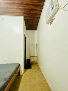 a small room with a bed and a ceiling at Emmanuel2A Homestay in San Vicente