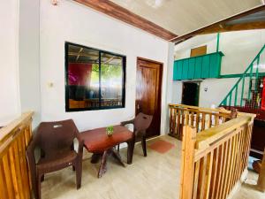 a dining room with a table and two chairs at Emmanuel2A Homestay in San Vicente