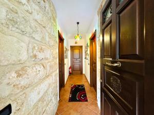 a hallway with a stone wall and a door at Casale Orioles in Torretta