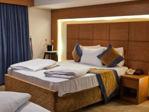 En eller flere senge i et værelse på فندق جنة الحسين Janat Alhussain Hotel