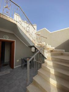 a staircase leading to a house with a table at Dar Hamma in Tozeur