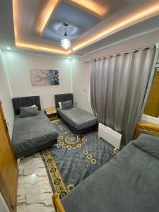a living room with two beds and a window at Dar Hamma in Tozeur