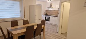 a kitchen and dining room with a table and chairs at Sson-Appartments in Detmold