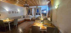 a living room with a couch and a table and chairs at Skiprivat in Ružomberok