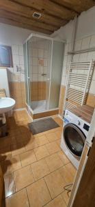 a bathroom with a shower and a washing machine at Skiprivat in Ružomberok +45 photos