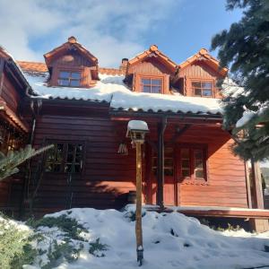 a log cabin with snow on the roof at "Koloc dom drewniany " in Ujsoły