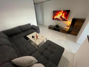 a living room with a couch and a fireplace at Second home apartment - gold in Kustići