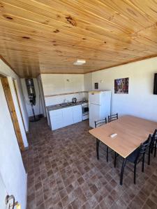 a kitchen with a wooden ceiling and a table and chairs at Complejo Balcarce in San Rafael