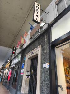 a store front with a sign above the door at Hostal Plaza Boutique - Solo adultos in Zaragoza