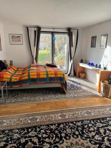 a bedroom with a bed and a large window at Gästewohnung Karin in Fjelby