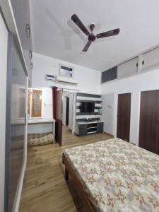 a bedroom with a bed and a ceiling fan at Bikaner House in Bikaner