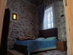 a bedroom with a bed in a stone wall at الشاميه سانت كاترين in Saint Catherine