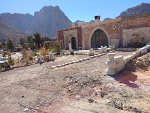 a building in a desert with a mountain in the background at الشاميه سانت كاترين in Saint Catherine