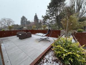 a wooden patio with a chair and a swing at Le chalet O'Perché - Wissembourg in Wissembourg