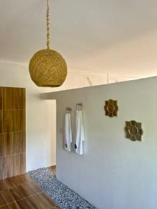 a bathroom with white towels hanging on a wall at Hotel talú tayrona in El Zaino
