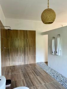 a bathroom with a shower and a toilet at Hotel talú tayrona in El Zaino