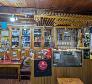 a shop with a counter with a table and a counter at Everest hotel in Phāphlu
