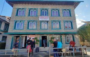 a group of people standing in front of a building at Everest hotel in Phāphlu