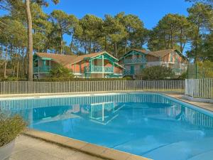 ein Haus mit einem Swimmingpool vor dem Haus in der Unterkunft T3 Duplex avec Piscine, Terrasse et Tennis à Soustons - FR-1-379-78 in Soustons