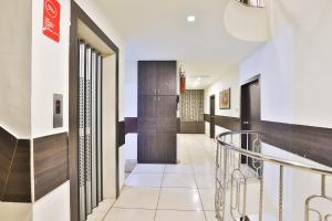 a hallway with a staircase in a building at Hotel O Park Inn in Rajkot