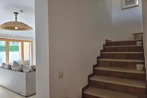 a staircase in a living room with a couch at SV Villa Burgau in Burgau +5 photos