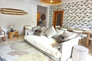 a living room with a white couch and a table at SV Villa Burgau in Burgau