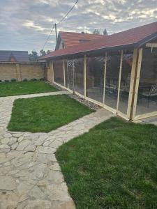 a patio of a house with a stone walkway at Vila Banstolija in Velika Remeta