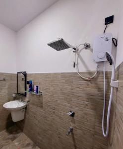 a shower in a bathroom with a toilet and a sink at Paboda Residency in Minuwangoda