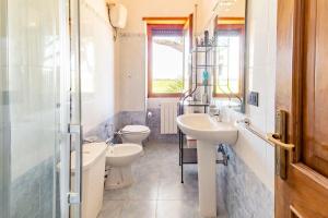 a bathroom with two sinks and two toilets at Le Anfore in Marino +48 photos