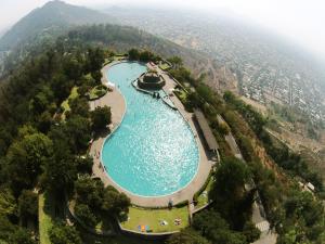 an aerial view of a pool of water in a mountain at La Chimba Hostel in Santiago
